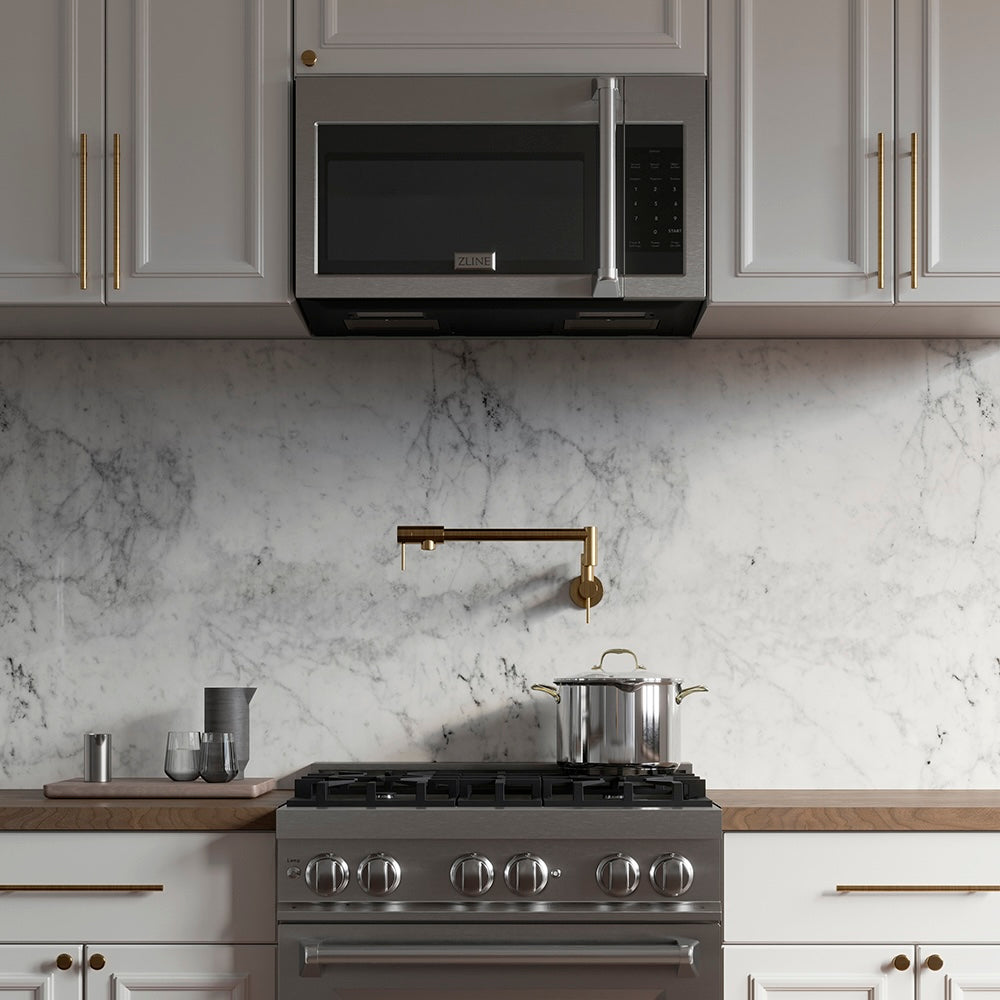 ZLINE 30 in. Recirculating Over the Range Convection Microwave Oven with Traditional Handle and Charcoal Filters in Stainless Steel (MWO-OTRCFH-30) in a kitchen with matching appliances, marble backsplash, and gold fixtures.