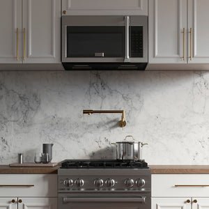 ZLINE 30 in. Recirculating Over the Range Convection Microwave Oven with Traditional Handle and Charcoal Filters in Stainless Steel (MWO-OTRCFH-30) in a kitchen with matching appliances, marble backsplash, and gold fixtures.