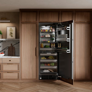 ZLINE 30 in. 16.7 cu. ft. Panel Ready Column Refrigerator with Graphite Gray Interior (RBCRV-30) in a modern kitchen with the unit open, displaying various food items.