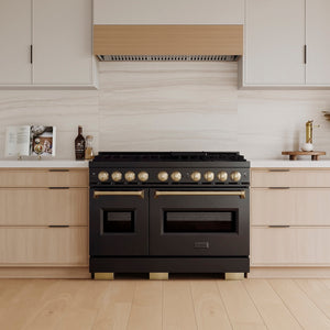 ZLINE Autograph Edition 48 in. 6.7 cu. ft. Classic Dual Fuel Range with 8 Burner DuoPro™ Cooktop and Dual Ovens in Black Stainless Steel and Champagne Bronze Accents (PCDRBZ-48-CB) in a custom kitchen with light wood cabinets, front.