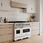 ZLINE 48 in. 6.7 cu. ft. Classic Dual Fuel Range with 8 Burner DuoPro™ Cooktop and Dual Ovens in Satin Stainless Steel with White Matte Doors (PCDRS-WM-48) in a custom kitchen with light wood cabinets, angled.