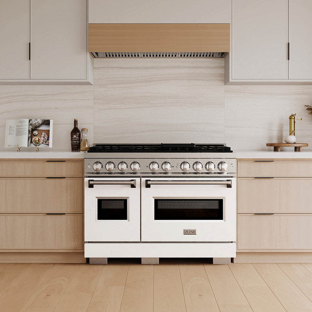 ZLINE 48 in. 6.7 cu. ft. Classic Gas Range with 8 Burner DuoPro™ Cooktop and Dual Ovens with White Matte Doors (PCGR-WM-48) in a custom kitchen with light wood cabinets, front.