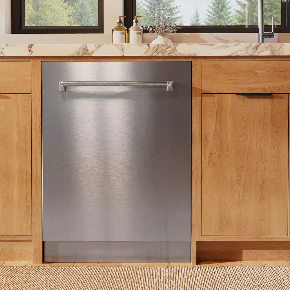 ZLINE Autograph Edition 24 in. Monument Series 3rd Rack Dishwasher with Auto Door Open Drying, 44dBa, Stainless Steel Panel with Polished Nickel Helix Handle (DWMTZ-30424-KPN) in a kitchen with wooden cabinets and a window view.