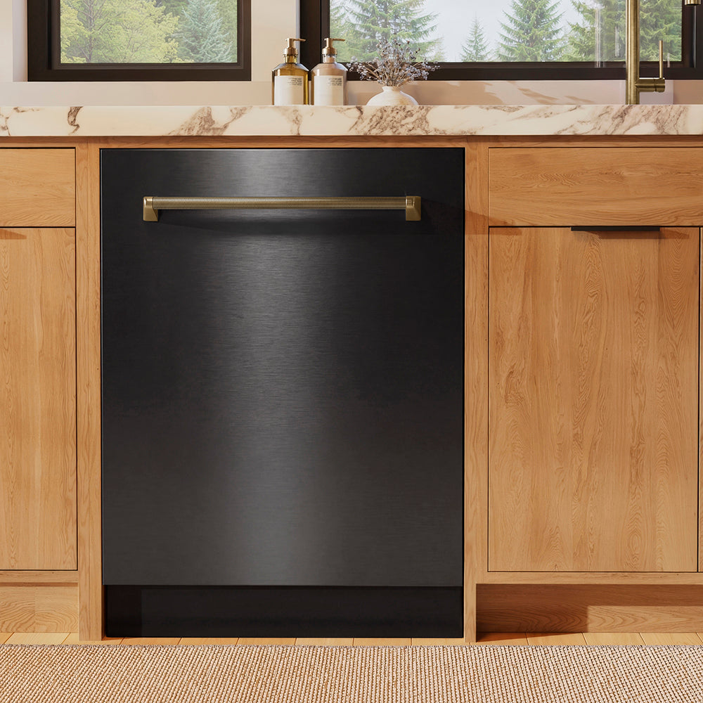 ZLINE Autograph Edition 24 in. Monument Series 3rd Rack Dishwasher with Auto Door Open Drying, 44dBa, Black Stainless Steel Panel with Champagne Bronze Helix Handle (DWMTZ-BS-24-KCB) in a kitchen with wooden cabinets and a window view.