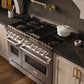 ZLINE 48 in. 6.7 cu. ft. Classic Dual Fuel Range with 8 Burner DuoPro™ Cooktop and Dual Ovens in Satin Stainless Steel (PCDRS-48) in a designer kitchen with wood details and dark marble backsplash, angled.