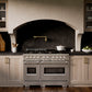 ZLINE 48 in. 6.7 cu. ft. Classic Dual Fuel Range with 8 Burner DuoPro™ Cooktop and Dual Ovens in Satin Stainless Steel (PCDRS-48) in a designer kitchen with wood details and dark marble backsplash, front.
