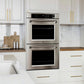 ZLINE 30 in. Professional True Convection Double Wall Oven with Air Fry and Self Clean in Stainless Steel (WAD-30) in a modern kitchen with white cabinets and marble countertops.