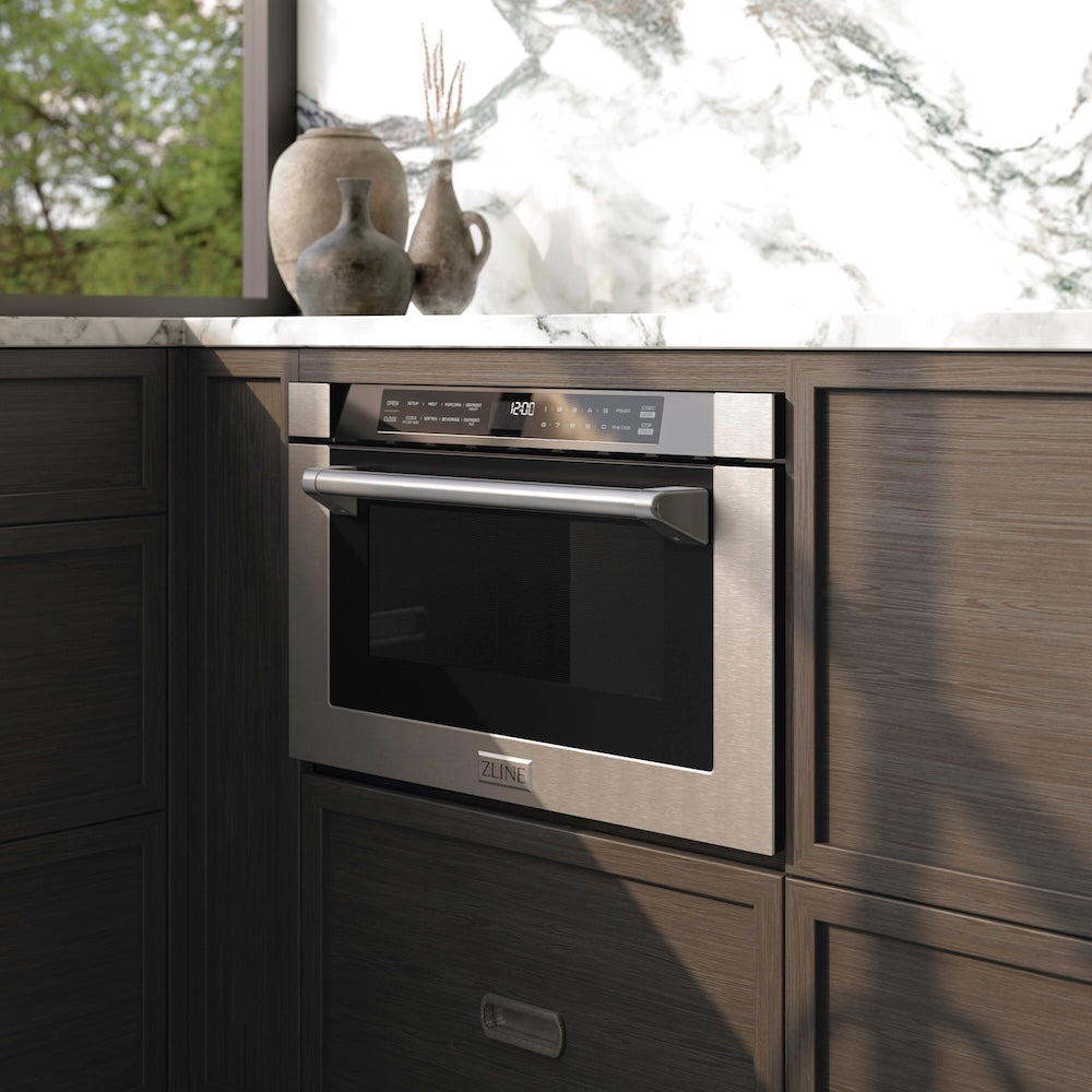 ZLINE 24 in. 1.2 cu. ft. Built-in Microwave Drawer with a Traditional Handle in Stainless Steel (MWD-1-H) embedded in wooden kitchen cabinets with a window view.