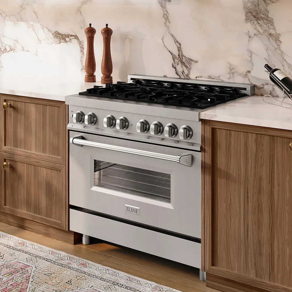 ZLINE 36 in. 4.6 cu. ft. Legacy Dual Fuel Range with 6 Burner Gas Cooktop and Electric Convection Oven in Stainless Steel (RA36) in a kitchen with wooden cabinets and marble backsplash