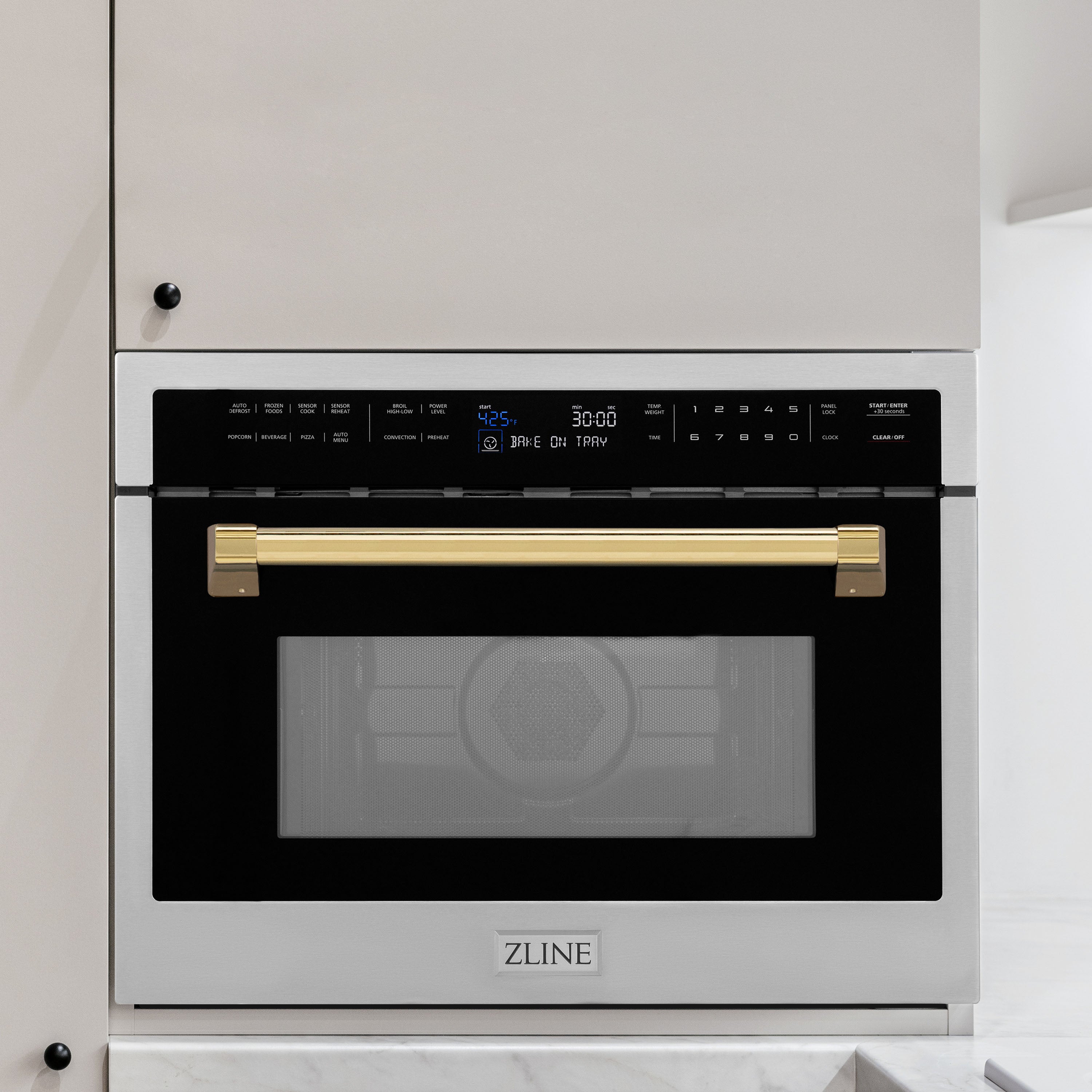 ZLINE Autograph Edition 24 in. 1.6 cu ft. Built-in Convection Microwave Oven in Stainless Steel with Polished Gold Accents built-in to white kitchen wall.