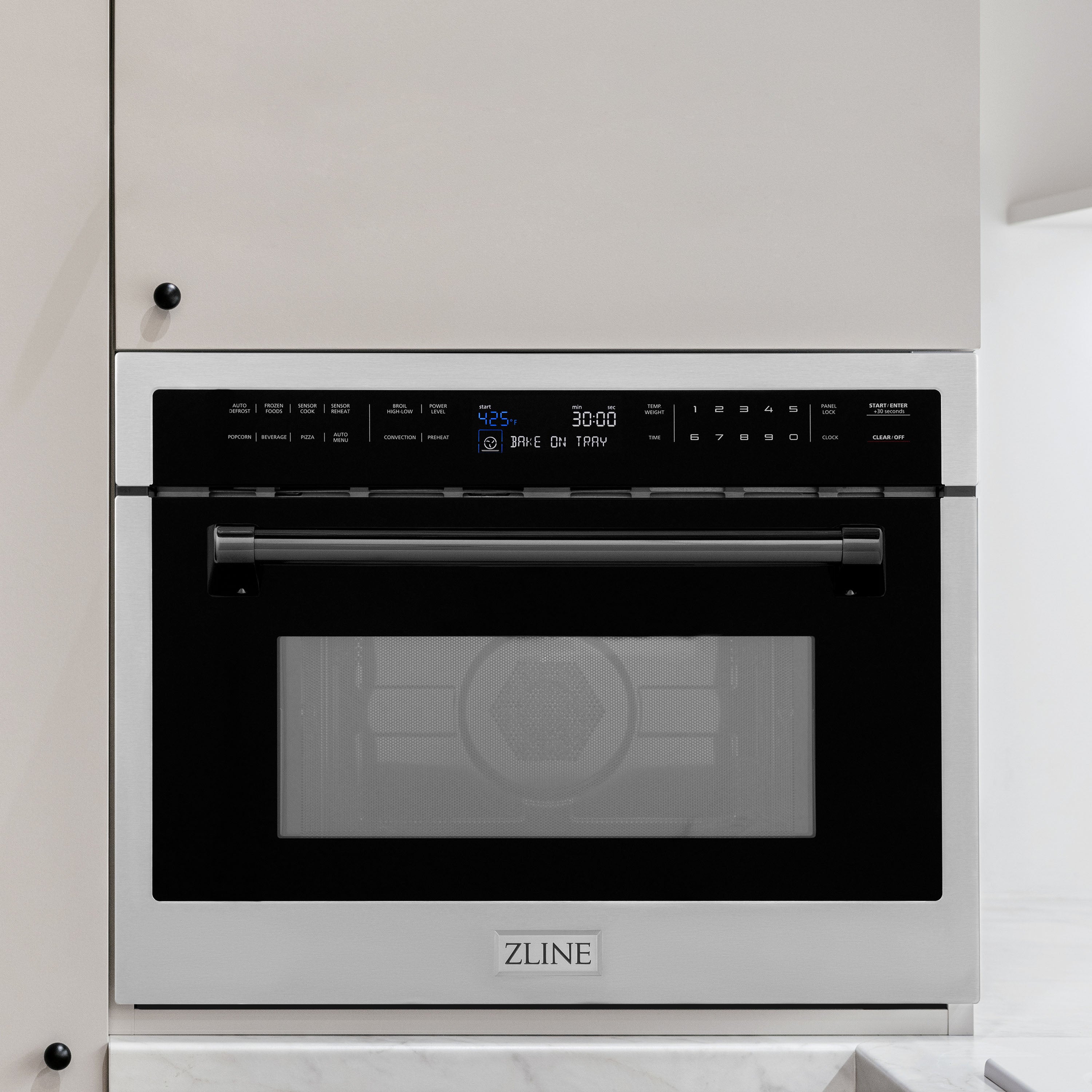 ZLINE Autograph Edition 24 in. 1.6 cu ft. Built-in Convection Microwave Oven in Stainless Steel with Matte Black Accents built-in to white kitchen wall.