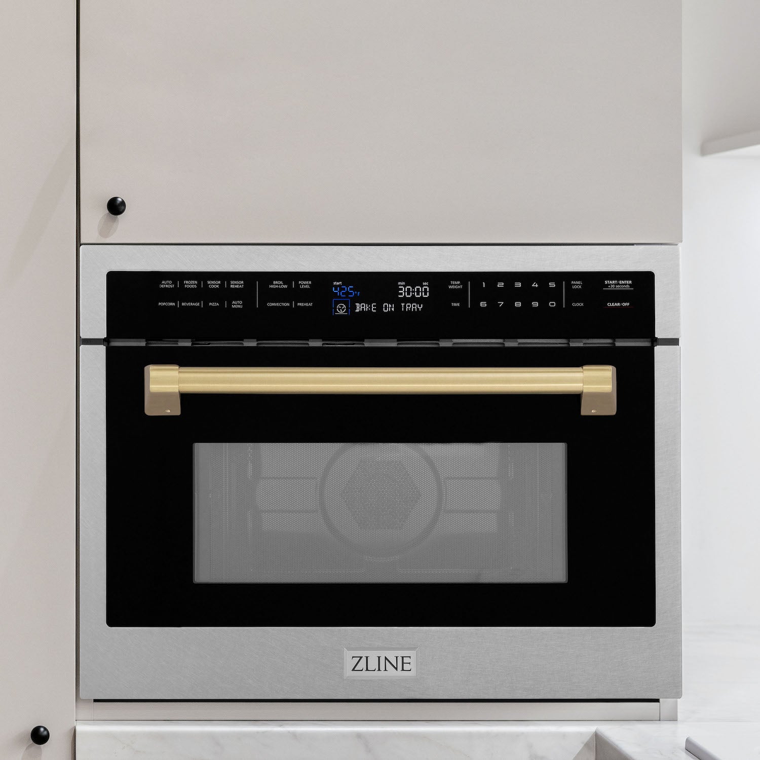 ZLINE Autograph Edition 24 in. 1.6 cu ft. Built-in Convection Microwave Oven in DuraSnow Stainless Steel with Champagne Bronze Accents built-in to white kitchen wall.