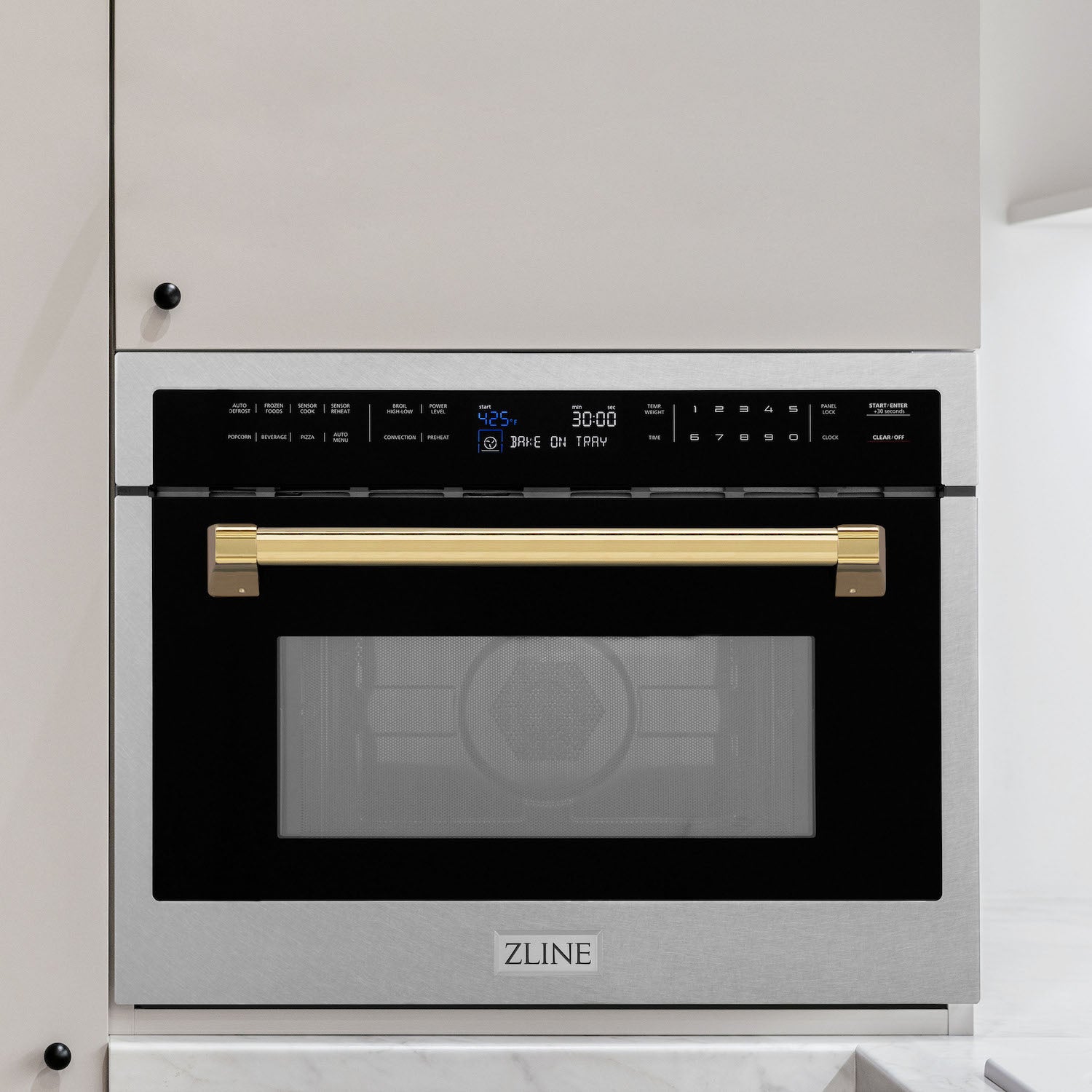 ZLINE Autograph Edition 24 in. 1.6 cu ft. Built-in Convection Microwave Oven in DuraSnow Stainless Steel with Polished Gold Accents built-in to white kitchen wall.