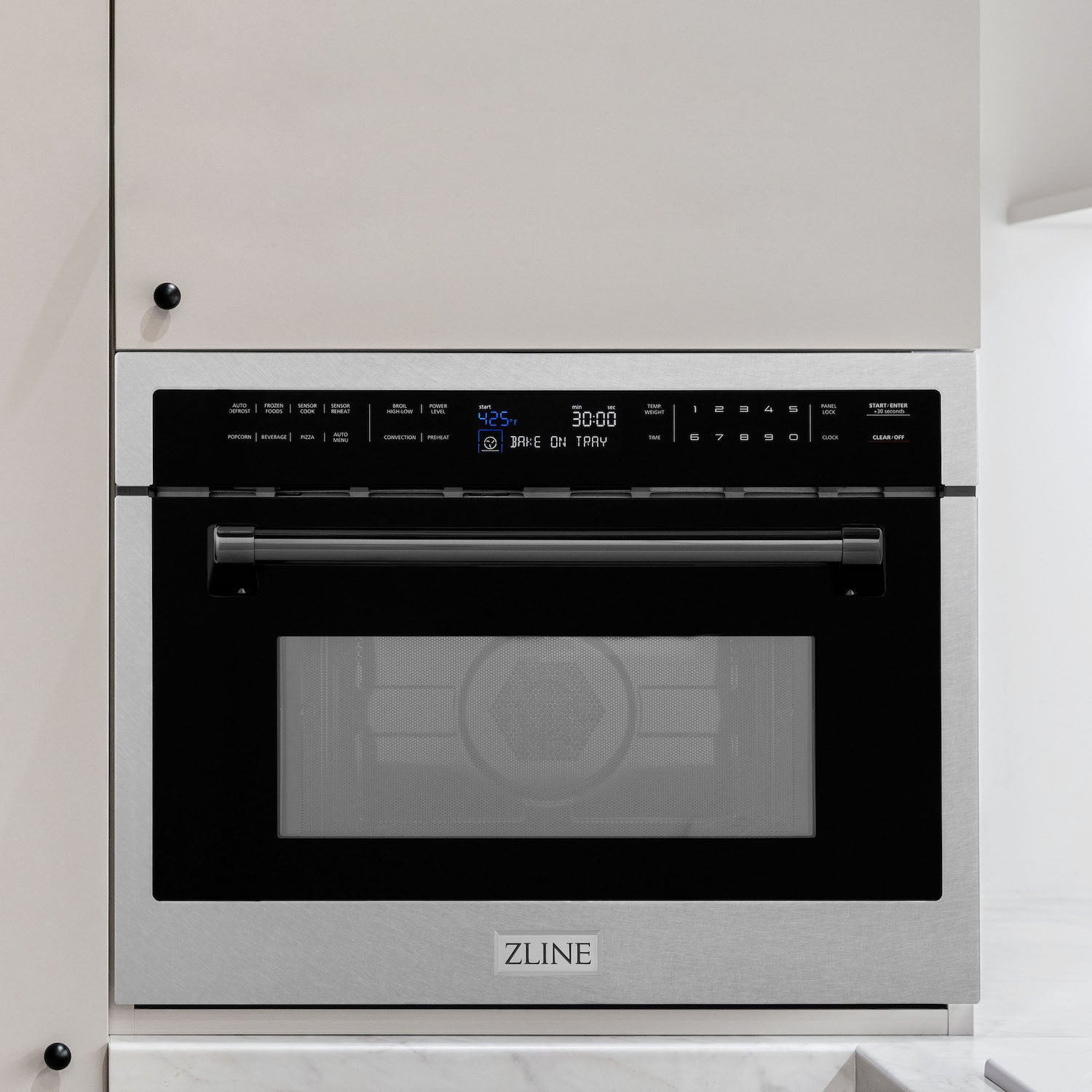 ZLINE Autograph Edition 24 in. 1.6 cu ft. Built-in Convection Microwave Oven in DuraSnow Stainless Steel with Matte Black Accents built-in to white kitchen wall.