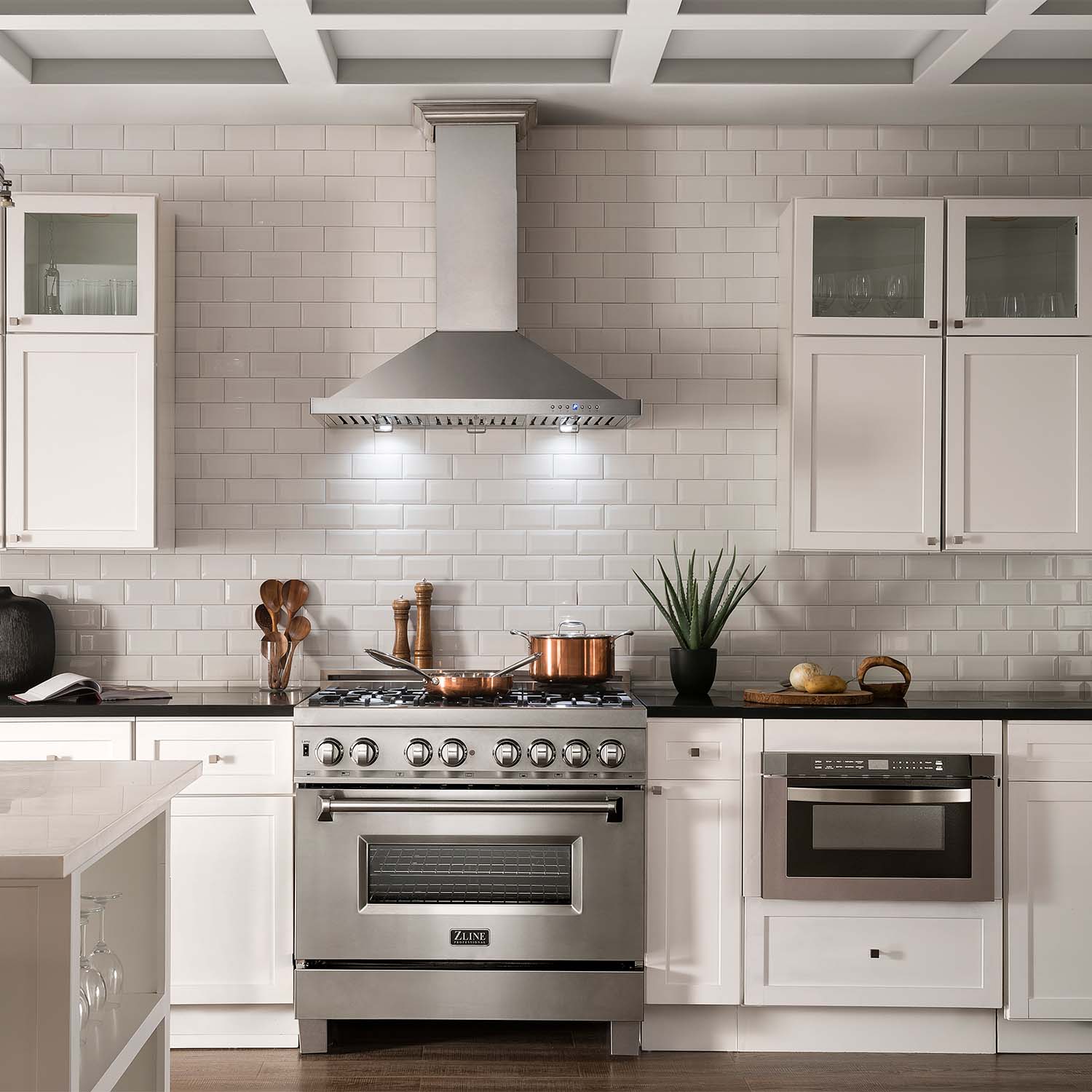 ZLINE appliance package with 36" range, 36" range hood, and microwave drawer in farmhouse-style kitchen.