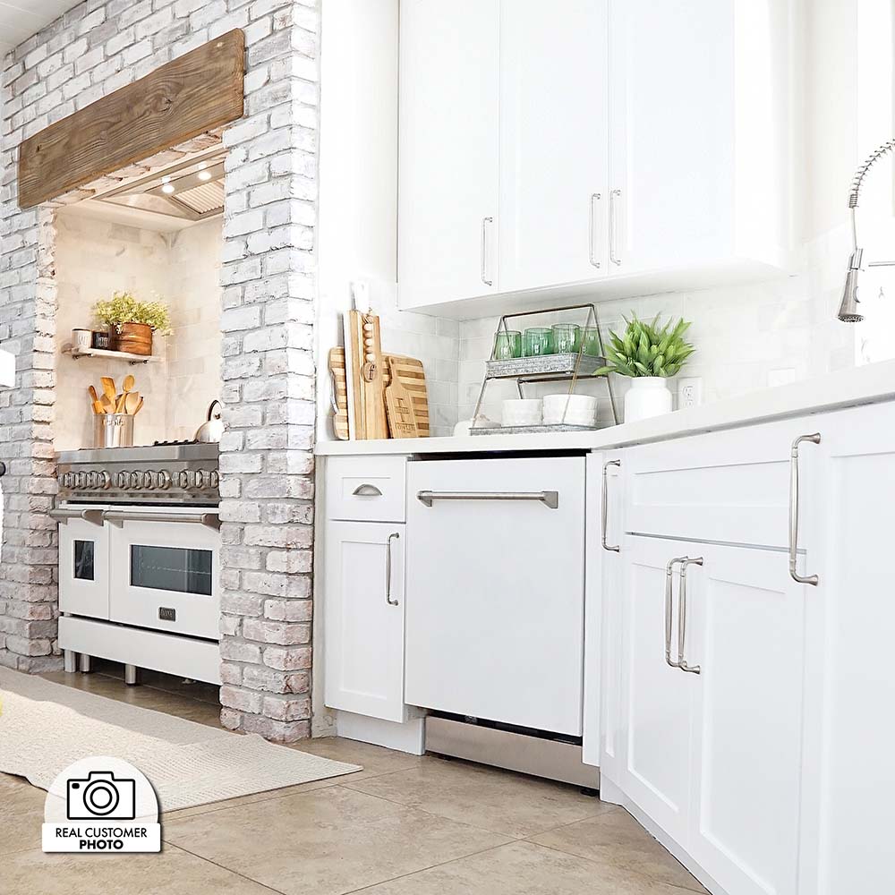 ZLINE 24 in. White Matte Top Control Built-In Dishwasher with Stainless Steel Tub and Traditional Style Handle, 52dBa (DW-WM-24) built-in to cabinets in a luxury kitchen.