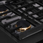 ZLINE 30 in. Autograph Edition Paramount Gas Rangetop with 4 Burners and Porcelain Cooktop in Black Stainless Steel with Champagne Bronze Accents (SRTBZ-30-CB) close-up detail, cast iron grates.