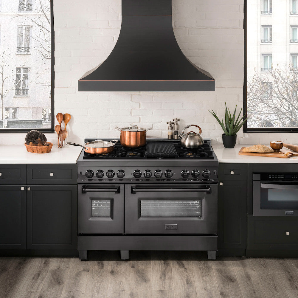 ZLINE 48" Black Stainless Steel Dual Fuel Range, Microwave Drawer, and Range Hood in a luxury apartment kitchen.