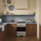 ZLINE 24 in. 3.2 cu. ft. Marino Induction Range with 3 Element Cooktop and Electric Convection Oven in Stainless Steel (MINR24) in a designer kitchen with custom details.