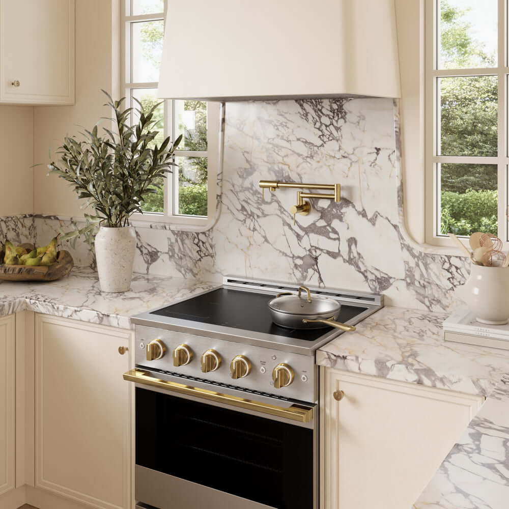 ZLINE Autograph Edition 30 in. 4.2 cu. ft. Marino Induction Range with 4 Element Cooktop and Electric Convection Oven in Stainless Steel with Polished Gold Accents (MINRZ-30-G) in a designer kitchen with custom details.