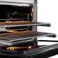 ZLINE Autograph Edition 36 in. 5.2 cu. ft. Paramount Dual Fuel Range with 6 Burner DuoPro™ Cooktop and Electric Convection Oven in Satin Stainless Steel with Black Matte Door and Polished Gold Accents (PSDRSZ-BLM36-G) side, oven open showing racks extended.
