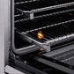 ZLINE Autograph Edition 30 in. 4.2 cu. ft. Paramount Induction Range with 4 Element Cooktop and Electric Convection Oven in Satin Stainless Steel with Champagne Bronze Accents (SINRSZ-30-CB) close-up, open oven with racks extended, showing interior components.
