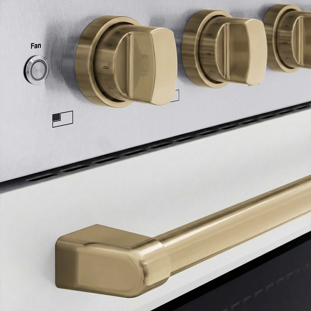 ZLINE Autograph Edition 36 in. 5.2 cu. ft. Paramount Induction Range with 5 Element Cooktop and Electric Convection Oven in Satin Stainless Steel with White Matte Door and Champagne Bronze Accents (SINRSZ-WM-36-CB) close-up of oven and cooktop knob controls.