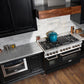 ZLINE 48 in. 6.0 cu. ft. Legacy Dual Fuel Range with 7 Burner Gas Cooktop and 2 Electric Ovens in Stainless Steel and Black Matte Doors (RA-BLM-48) in a luxury kitchen.