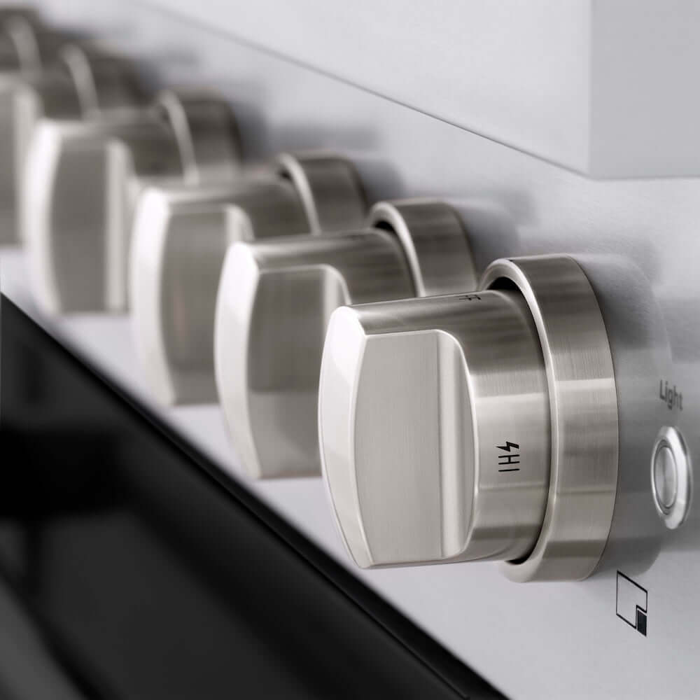 Stainless steel knobs close-up on ZLINE gas range with black matte oven door.