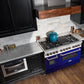 ZLINE 48 in. 6.0 cu. ft. Legacy Dual Fuel Range with 7 Burner Gas Cooktop and 2 Electric Ovens in Stainless Steel and Blue Gloss Doors (RA-BG-48) in a luxury kitchen.