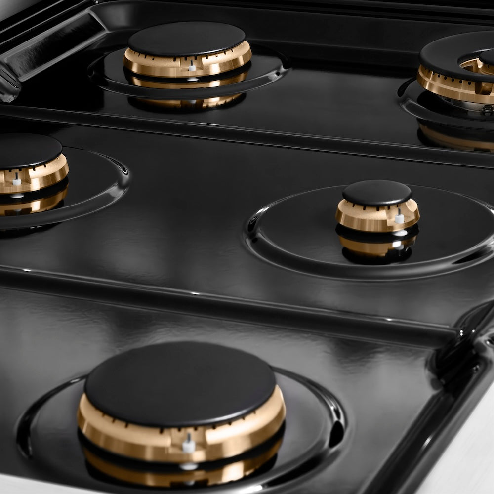 ZLINE Autograph Edition 36 in. 5.2 cu. ft. Paramount Dual Fuel Range with 6 Burner Gas Cooktop and Electric Convection Oven in Stainless Steel with Champagne Bronze Helix Handle and Knob Accents (SDRZ-36-KCB) black porcelain cooktop and brass burners with no grates.