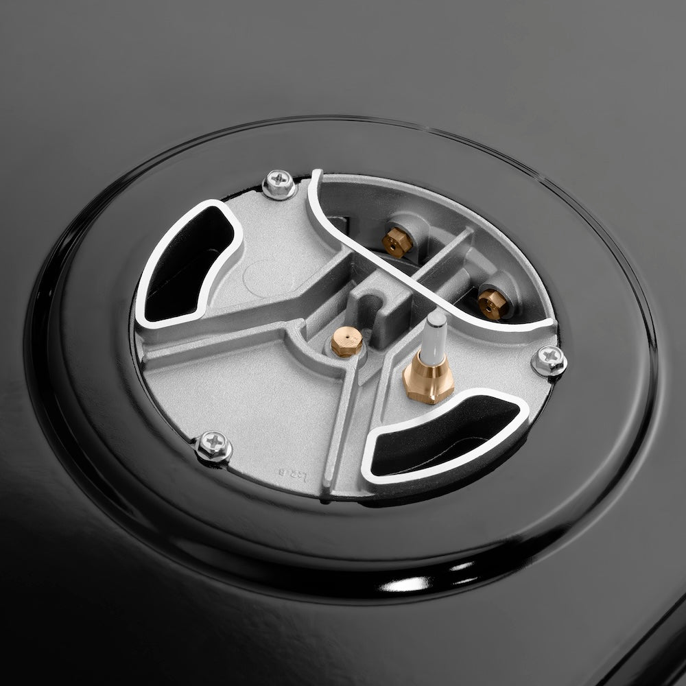 ZLINE Autograph Edition 48 in. 6.7 cu. ft. Paramount Dual Fuel Range with 8 Burner DuoPro™ Cooktop and Dual Ovens in Stainless Steel with Polished Gold Helix Handles and Accents (PSDRZ-48-KG) under DuoPro™ brass burner close-up showing dual-port design.