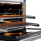 ZLINE Autograph Edition 36 in. 5.2 cu. ft. Paramount Gas Range with 6 Burner Cooktop and Convection Gas Oven in Stainless Steel with Polished Gold Helix Handle and Knob Accents (SGRZ-36-KG) side, open, close-up, racks extended showing interior details.