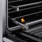 ZLINE Autograph Edition 24 in. 3.2 cu. ft. Paramount Induction Range with 3 Element Cooktop and Electric Convection Oven in Stainless Steel with Polished Gold Accents (SINRZ-24-G) close-up, open oven with racks extended, showing interior components.