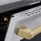 ZLINE Autograph Edition 36 in. 5.2 cu. ft. Paramount Induction Range with 5 Element Cooktop and Electric Convection Oven in Stainless Steel with Champagne Bronze Helix Handle and Knob Accents (SINRZ-36-KCB) oven door slightly open showing handle detail.