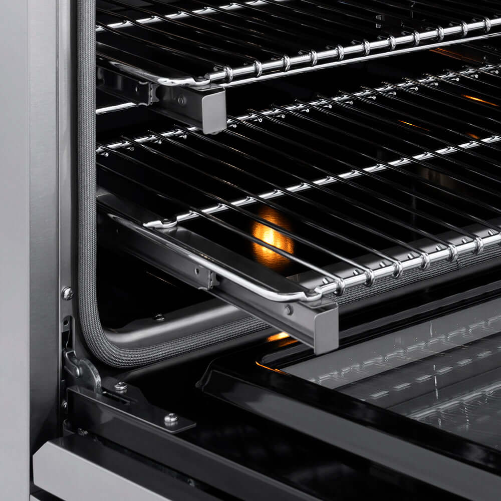 ZLINE Autograph Edition 36 in. 5.2 cu. ft. Paramount Induction Range with 5 Element Cooktop and Electric Convection Oven in Stainless Steel with Champagne Bronze Helix Handle and Knob Accents (SINRZ-36-KCB) close-up, open oven with racks extended, showing interior components.