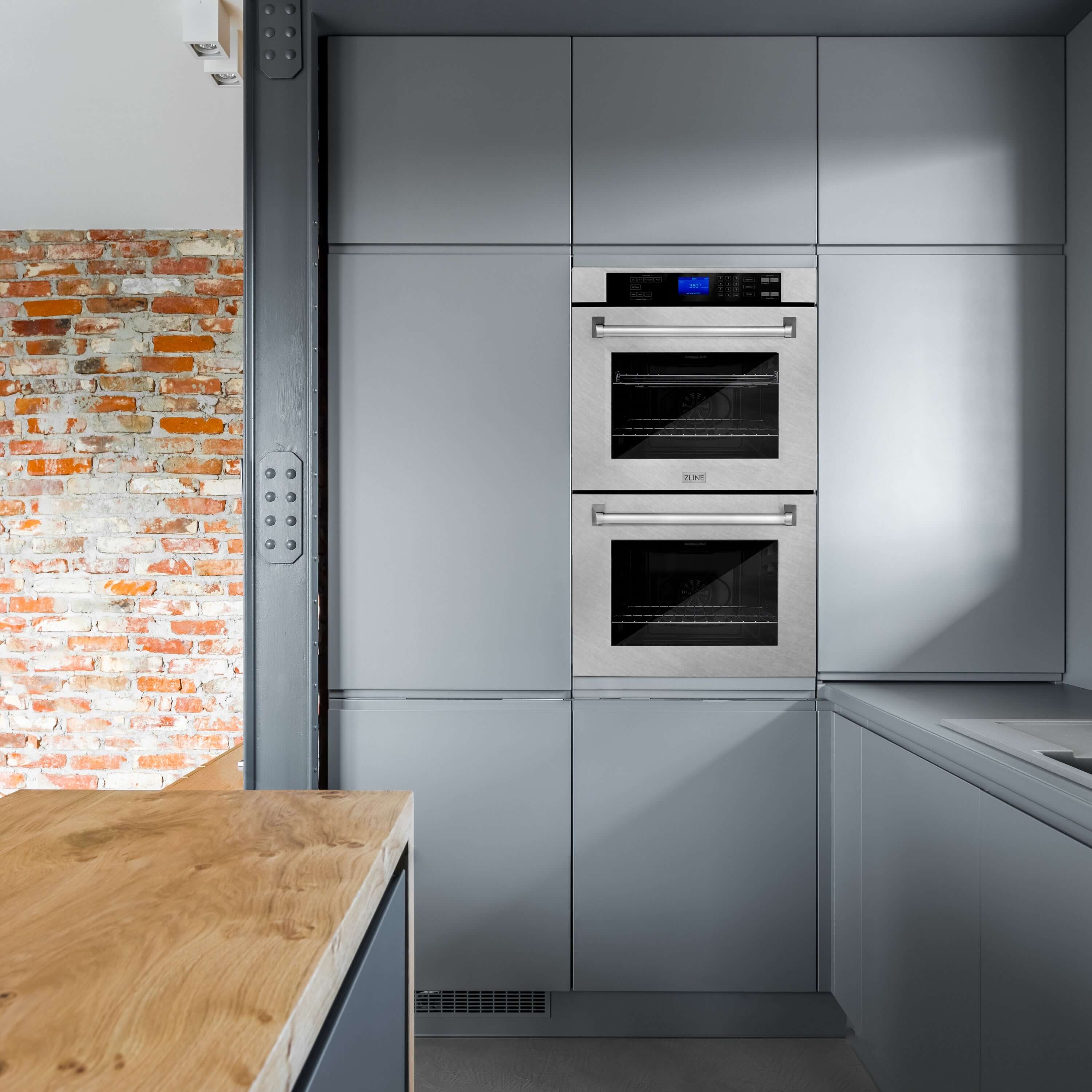 ZLINE double wall oven built-in to wall of modern industrial-style kitchen.