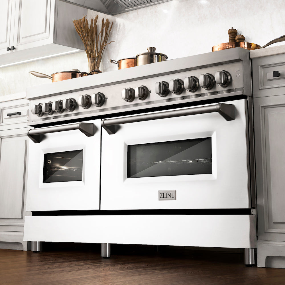 ZLINE 60 in. 7.4 cu. ft. Dual Fuel Range with Gas Stove and Electric Oven in Stainless Steel with White Matte Doors (RA-WM-60) from below in a luxury kitchen with cookware on cooktop.