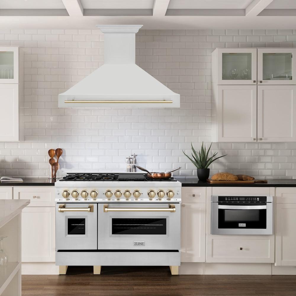 ZLINE Autograph Edition 48 in. Stainless Steel Range Hood with Stainless Steel Shell and Polished Gold Handle (8654STZ-48-G) in a farmhouse-style kitchen above matching range.