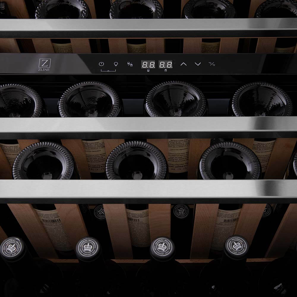 ZLINE Autograph Edition 24 in. Monument Dual Zone 44-Bottle Wine Cooler in Stainless Steel with Matte Black Accents (RWVZ-UD-24-MB) close-up, wine bottles one wooden shelves from below.