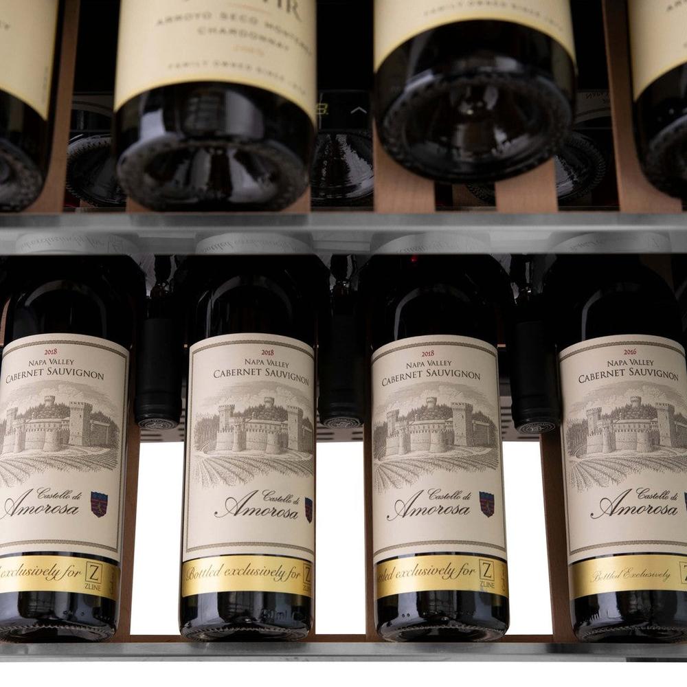 ZLINE Autograph Edition 24 in. Monument Dual Zone 44-Bottle Wine Cooler in Stainless Steel with Matte Black Accents (RWVZ-UD-24-MB) close-up, four bottles of Cabernet Sauvignon on extended wood shelf from above.