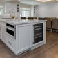 ZLINE Autograph Edition 24 in. Monument Dual Zone 44-Bottle Wine Cooler in Stainless Steel with Matte Black Accents (RWVZ-UD-24-MB) built-in to farmhouse kitchen island with marble countertop.