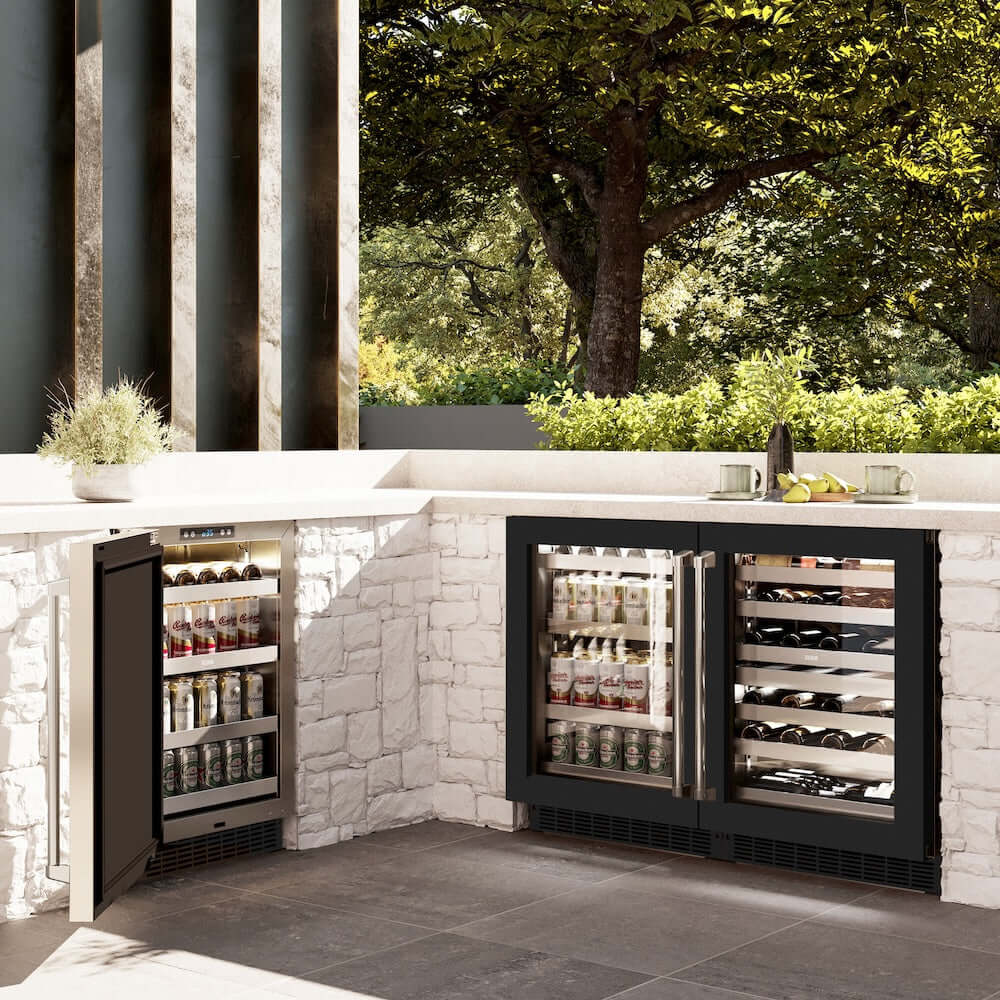 ZLINE 24 in. Touchstone Dual Zone 44 Bottle Wine Cooler With Black Matte Glass Door (RWDO-BLM-24) side, in an outdoor patio area against a stone wall and greenery.