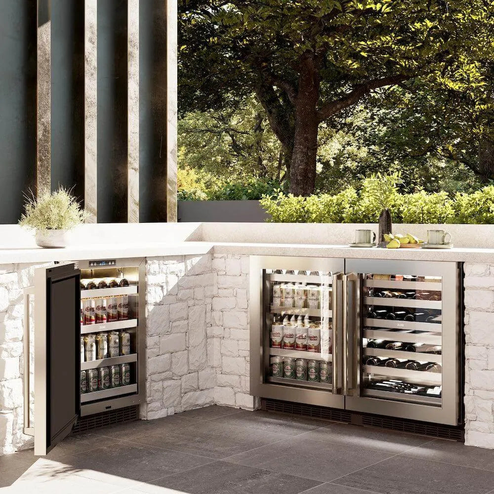 ZLINE 24 in. Touchstone Dual Zone 44 Bottle Wine Cooler With Stainless Steel Glass Door (RWDO-GS-24) side, in an outdoor patio area against a stone wall and greenery.