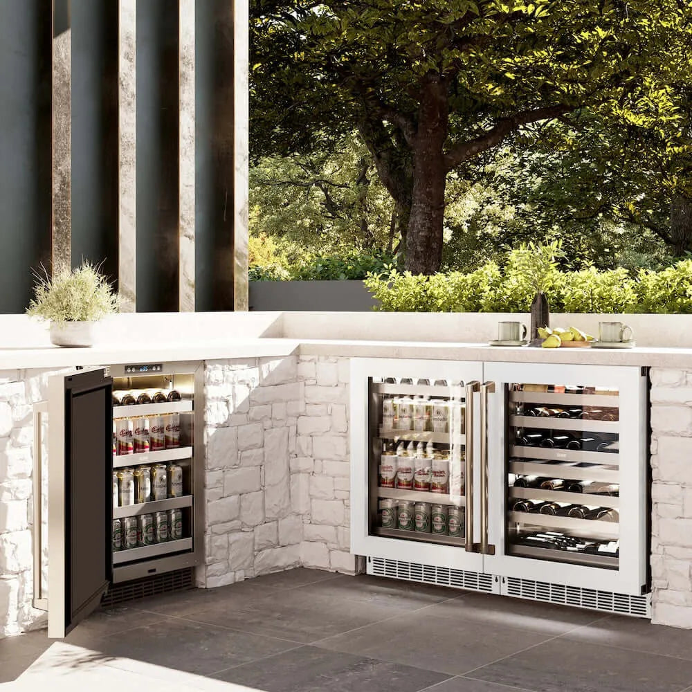 ZLINE 24 in. Touchstone 151 Can Beverage Fridge With White Matte Glass Door (RBSO-WM-24) side, in an outdoor patio area against a stone wall and greenery.