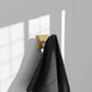 ZLINE Palisades Towel Hook in Champagne Bronze (RBCN1-HK-CB) with a black towel on a gray wall