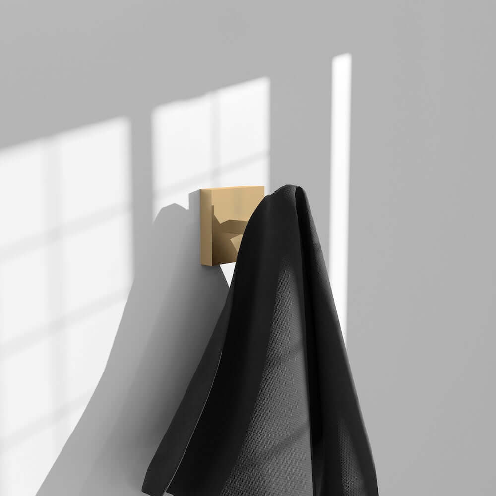 ZLINE Palisades Towel Hook in Champagne Bronze (RBCN1-HK-CB) with a black towel on a gray wall