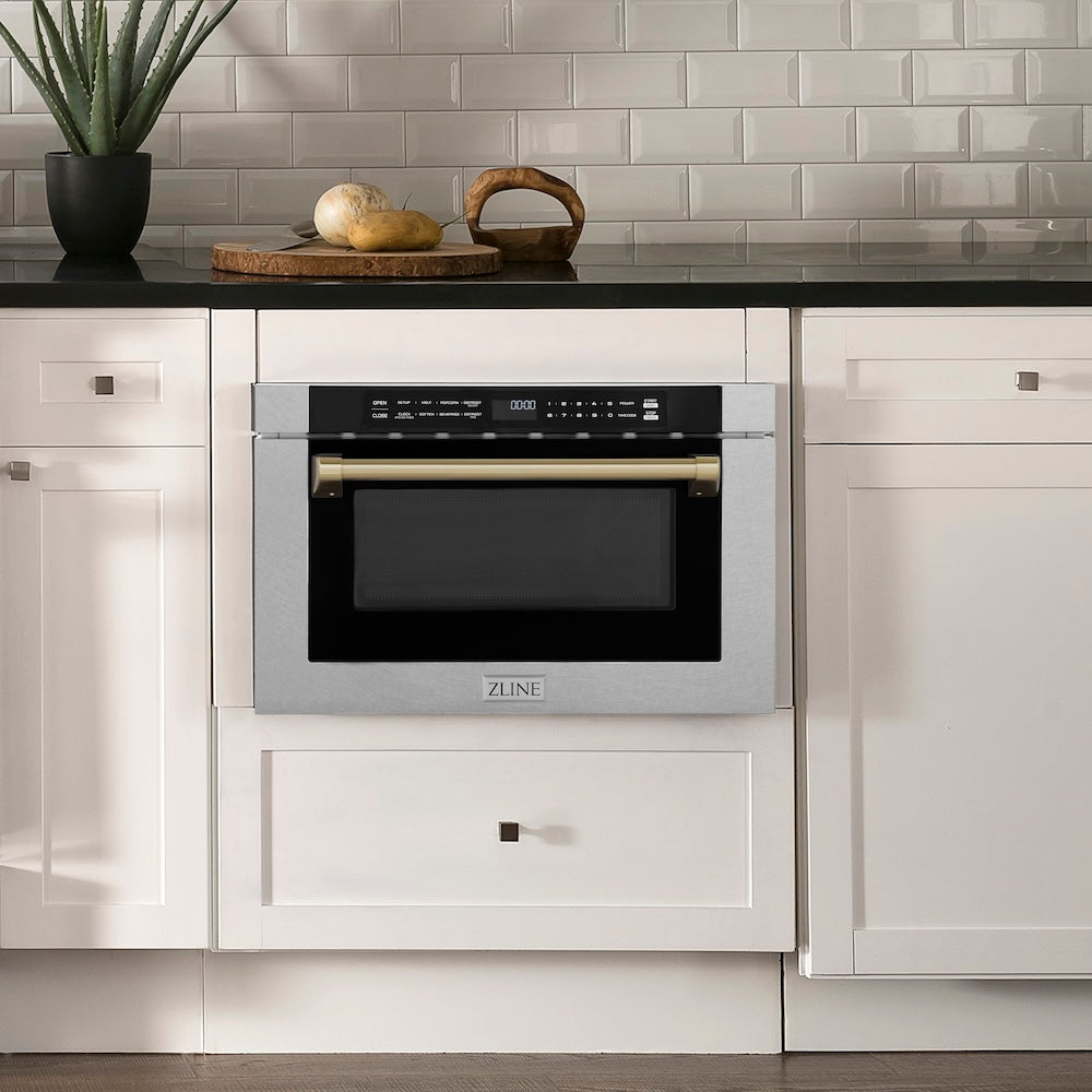 ZLINE Autograph Edition 24 in. 1.2 cu. ft. Built-in Microwave Drawer with a Traditional Handle in Satin Stainless Steel and Champagne Bronze Accents (MWDZ-1-SS-H-CB) embedded in white kitchen cabinets with a tiled backsplash.