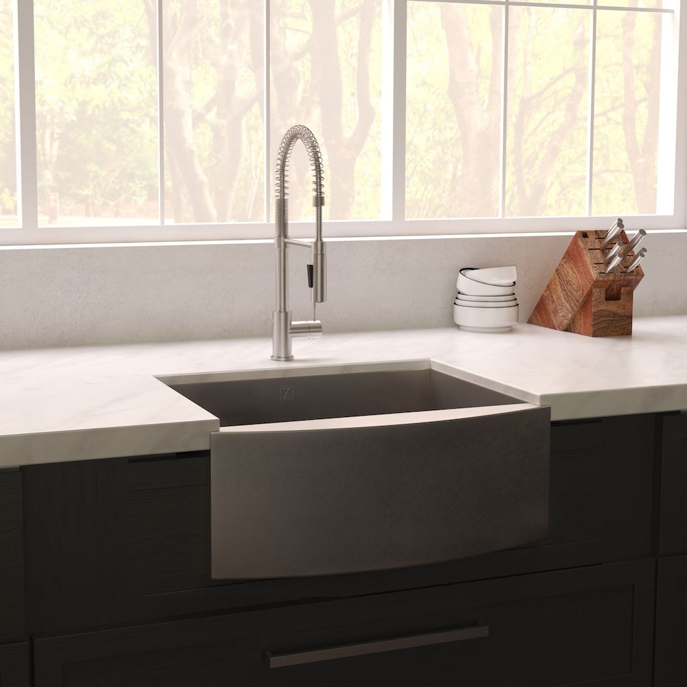ZLINE 33 in. Vail Farmhouse Apron Mount Single Bowl Kitchen Sink with Bottom Grid and Color Options (SAS-33) Satin Stainless Steel in a kitchen with a faucet.