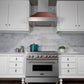 ZLINE Ducted Satin Stainless Steel Wall Mount Range Hood with Hand-Hammered Copper Shell and Size Options (8654HH) in a kitchen with gray marble countertop